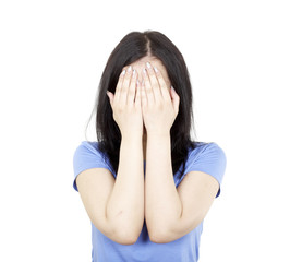 Fototapeta premium young girl covers her face on a white background