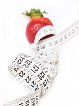 strawberry with measuring tape, diet concept