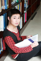 asian boy studying in library