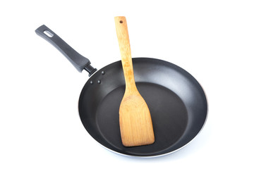 Wooden kitchen shovel in a frying pan