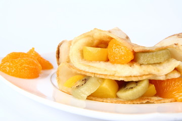 Pancakes stuffed with fruit (peach, kiwi, mandarin)