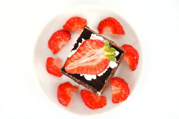 chocolate  cake with cream and  strawberry on white