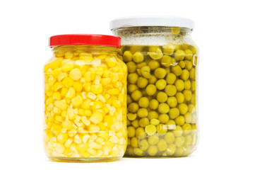 Various pickles in the glass jars on white