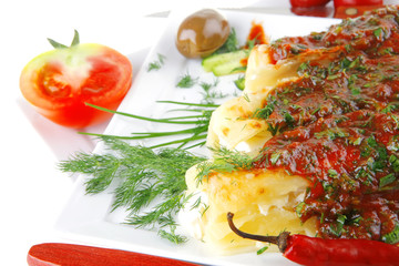 cannelloni with cheese on square white plate