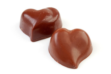 choclates in shape of hearts over white background