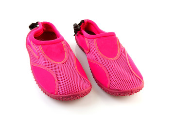 Pink water shoes over white background