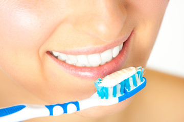 Woman healthy teeth closeup brushing concept