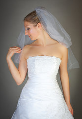 Young woman in wedding dress in studio