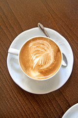 Cup of coffee with leaf