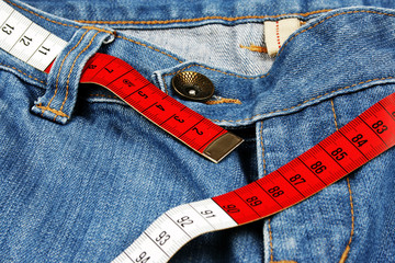 Blue jeans and measure tape isolated