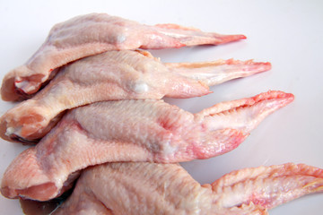 raw chicken wings on white background