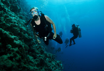 male scuba diver on coral reef