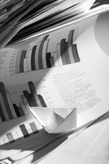 Business concept, paper boat and tsunami documents
