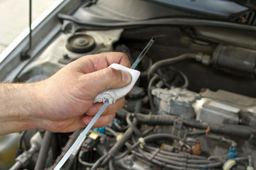 Details checking engine oil dipstick in the car