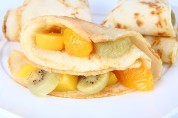 Pancakes stuffed with fruit on a plate