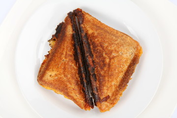 Toasted sandwich with cheese on a plate