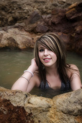 Woman sitting in the pool of water