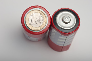 Scratched one euro coin on minus side of big C size battery