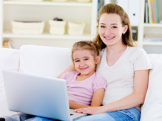 Woman with daughter with laptop
