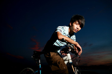 Fototapeta na wymiar young asian man with bike