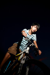 Obraz na płótnie Canvas young asian man with bike