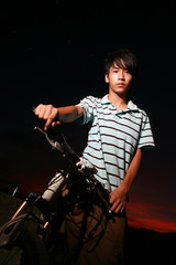 Fototapeta na wymiar young asian man with bike