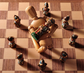 Pieces from an ecuadorian chess set, with a wooden art doll