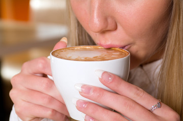 woman holding a cup of hot drink