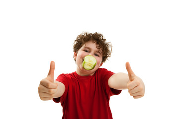 Boy eating green apple isolated on white background