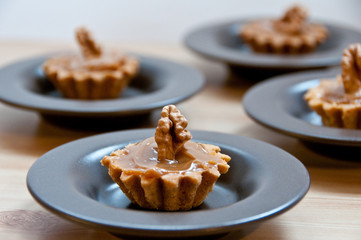 Cookies filled with caramel and decorated with walnut