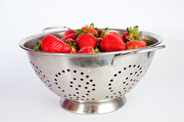 Red strawberries on a colander