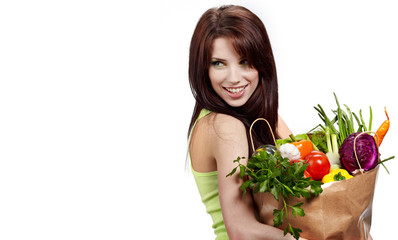 Woman with a shopping bag filled with nutritious fruit and veget