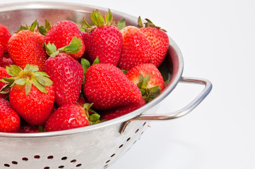 Red strawberries on a colander