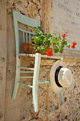 Old chair hanged to a wall