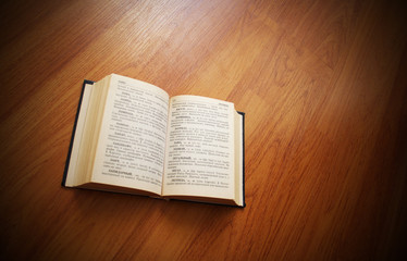 Fototapeta premium The book lays on a brown surface