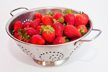Red strawberries on a colander
