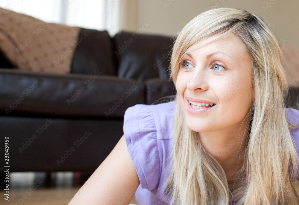 Wall mural Portrait of a beautiful woman lying on the floor