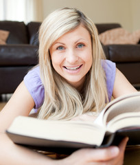 Smiling woman reading a book