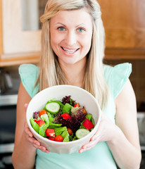 Caucasian woman showing a salad