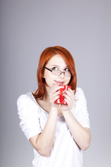 Red-haired businesswoman  keep red cup in hand