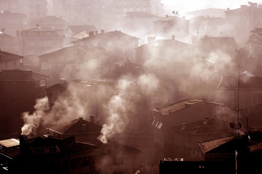 air pollution image of houses and smoke