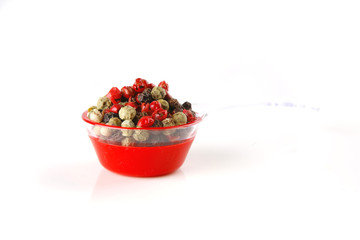 pepper in spoon on white
