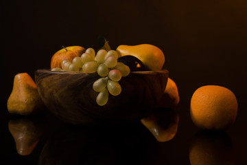 Still-life with fruit in a wooden dish