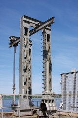 sluice construction on a pond on a background dark blue sky