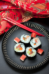 Sushi rolls on black dish