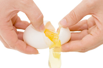 Hands breaking an egg