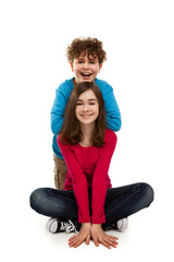 Girl and boy sitting on white background