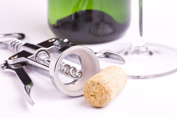 Cork, corkscrew, bottle of wine and glass