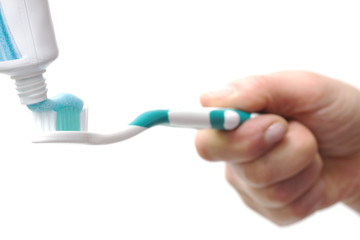 toothbrush with toothpaste in the hand