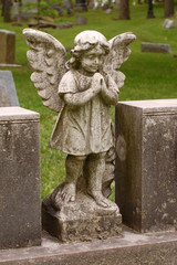 Standing angel with wings in cemetery